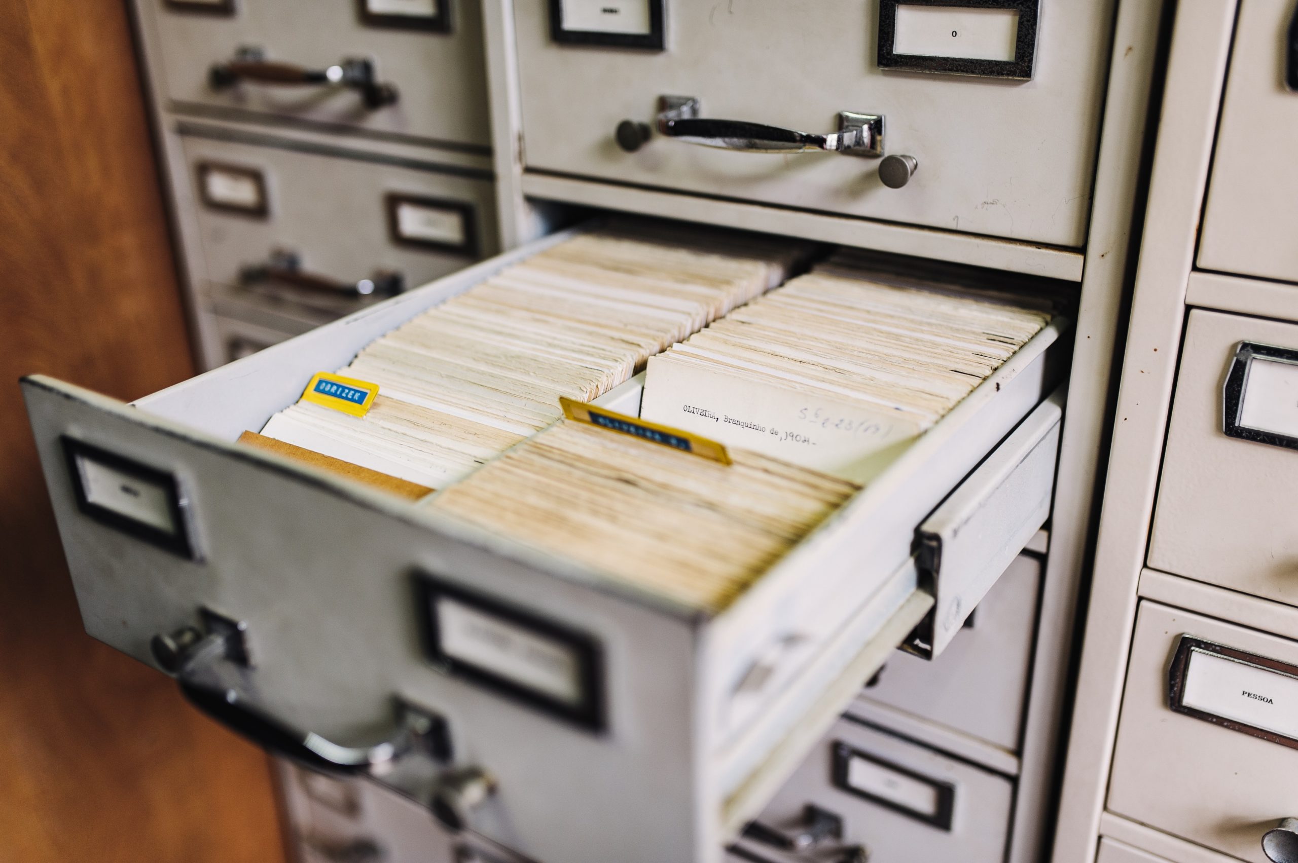 A filled file cabinet with one of its drawers pulled out